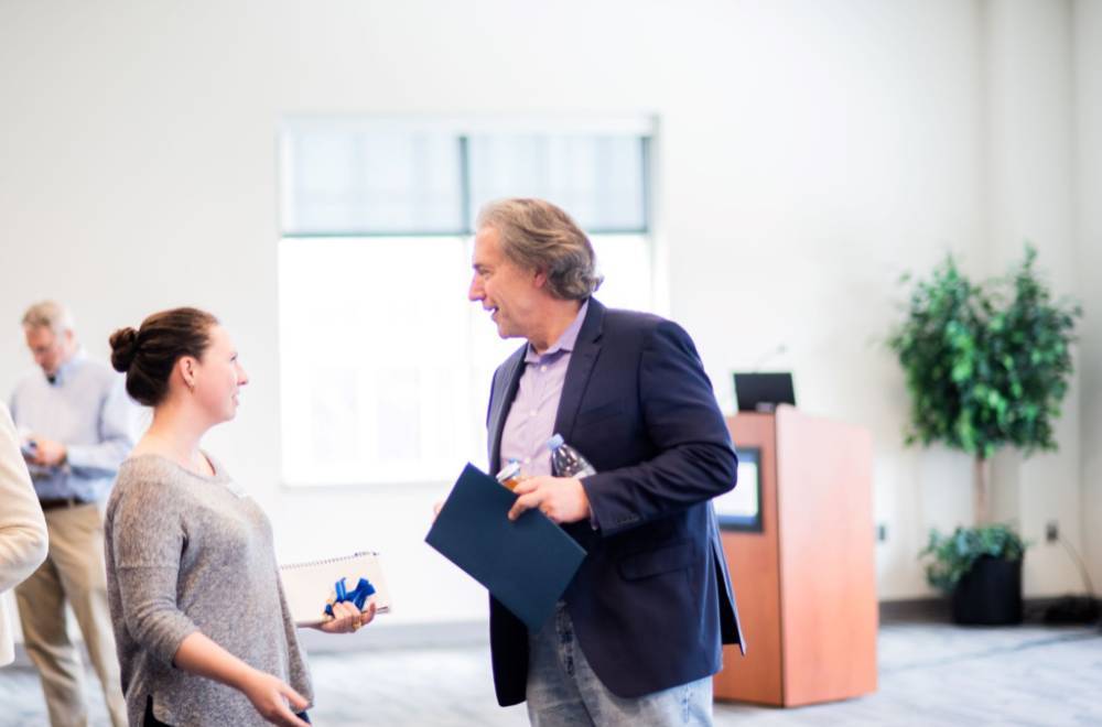 Brent Smith speaking with a student at a lecture